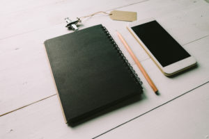 Canva - Flatlay Photo of Black Spiral Book Near Brown Pencil and White Smartphone