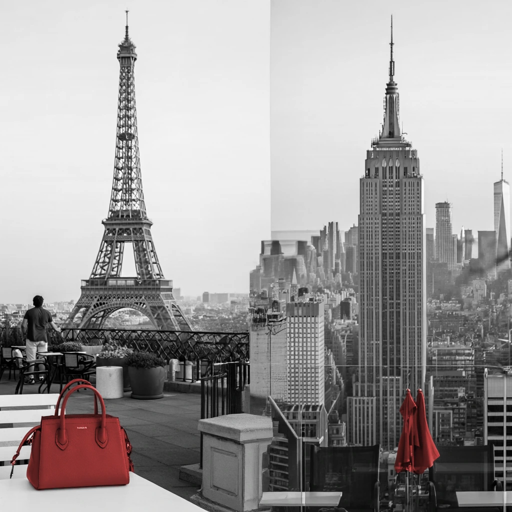 Red handbag on rooftop terrace with Eiffel Tower and Empire State Building — connecting Paris and New York for business travel
