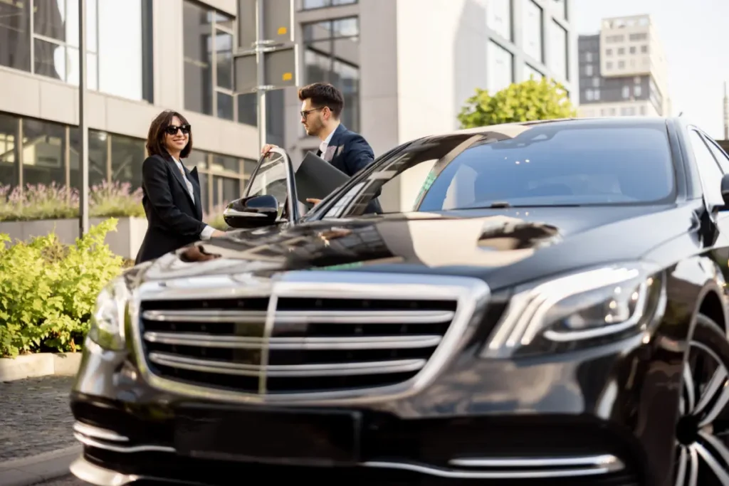Executive chauffeur service for corporate travel, business clients arriving by luxury car in city center