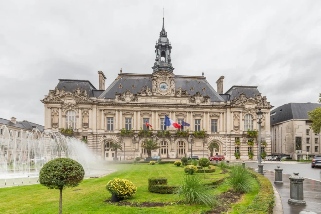 Hotel de Ville in Tours, Loire Valley, France, featuring historic architecture, landscaped gardens, and a fountain in front of the building.