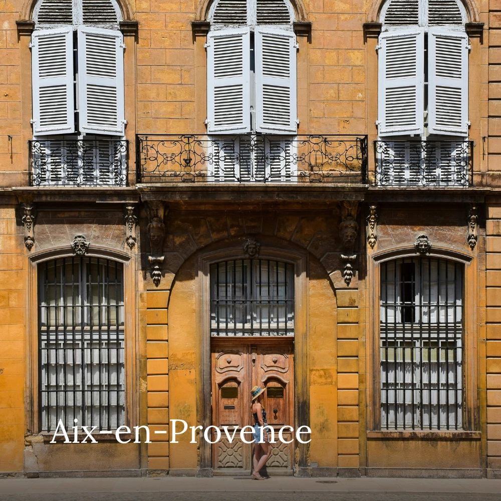 Historic Provençal building with traditional shutters and ornate balconies in Aix-en-Provence, France