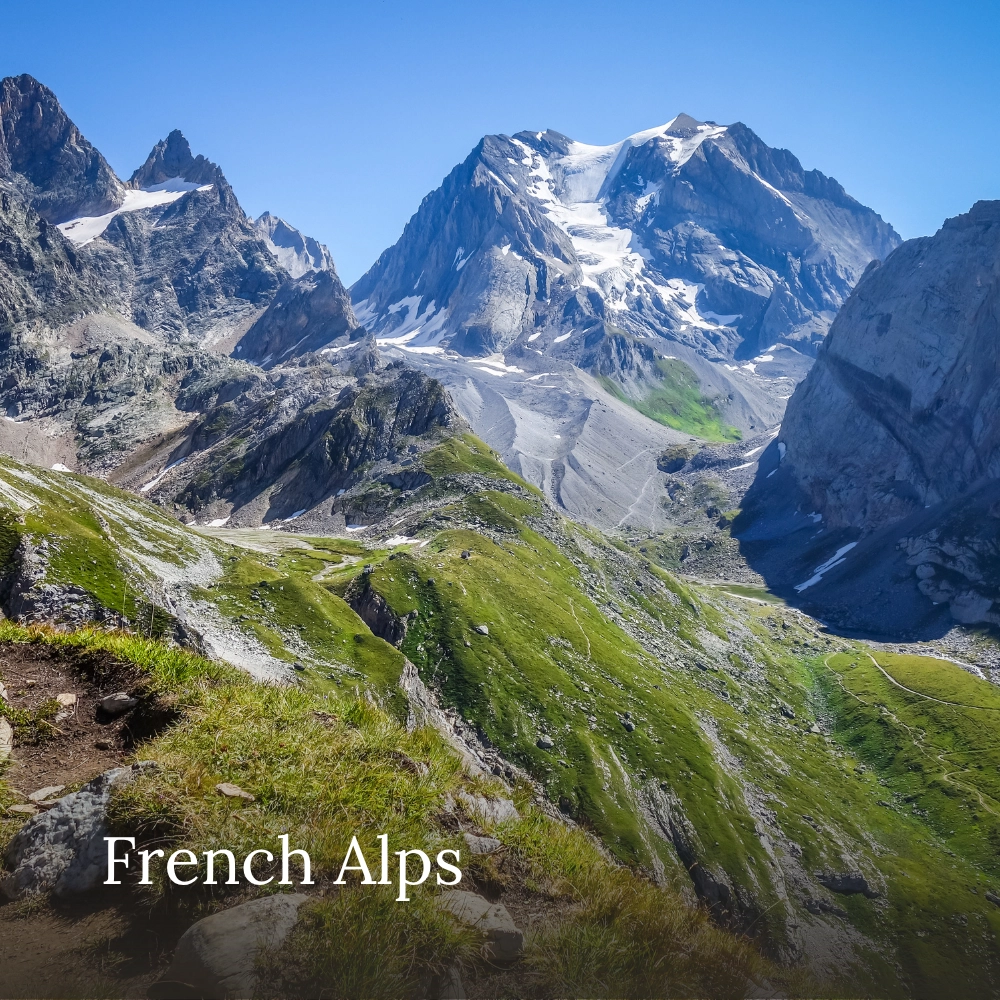 Dramatic mountain peaks, rocky slopes and green Alpine meadows in the French Alps during summer