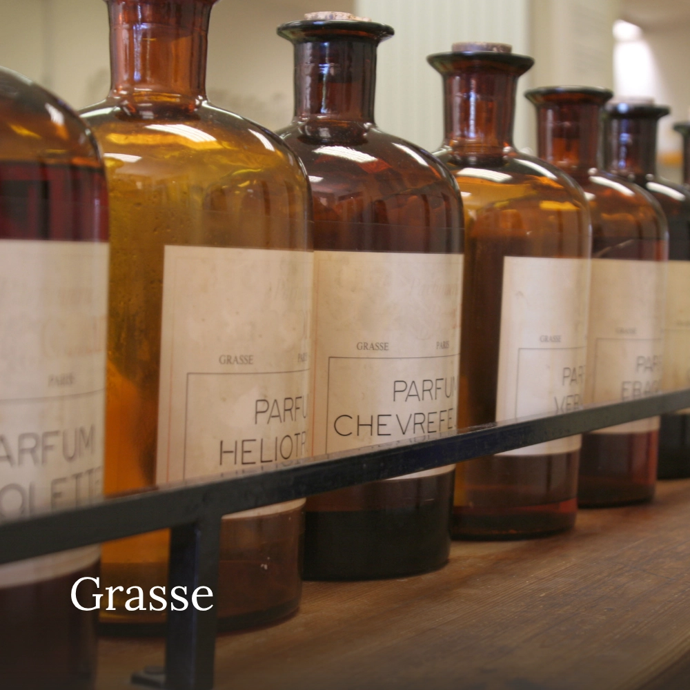 Vintage amber perfume bottles displayed in a traditional perfumery in Grasse, France
