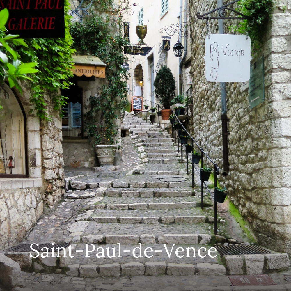 Historic cobblestone staircase lined with art galleries and stone buildings in Saint-Paul-de-Vence, France